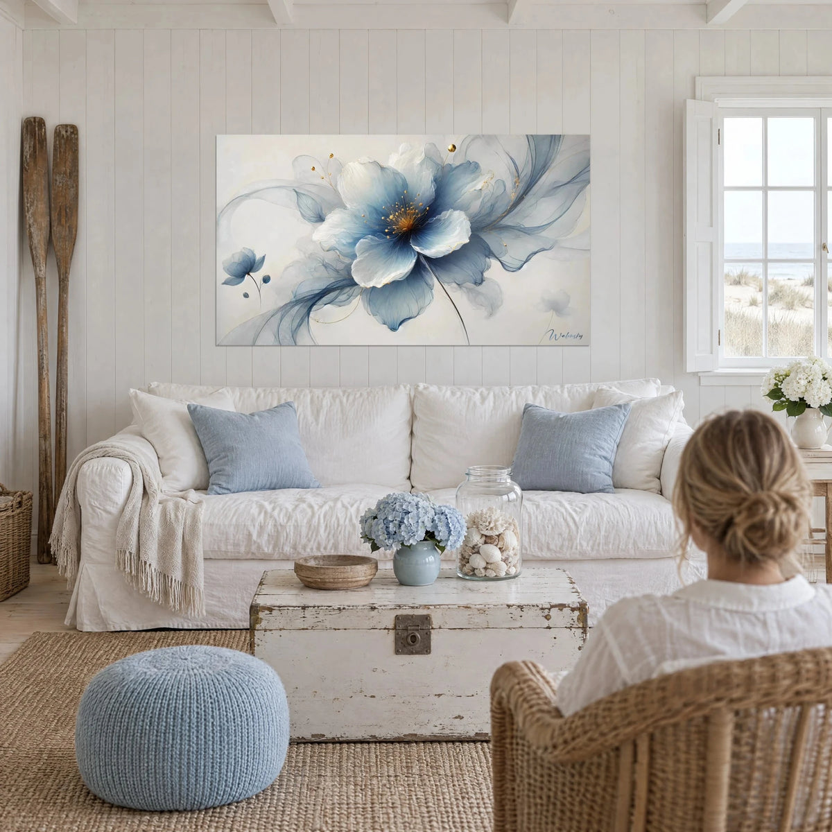 Wall art large blue flower with translucent petals, golden heart, ivory background, above a sofa in a bright living room