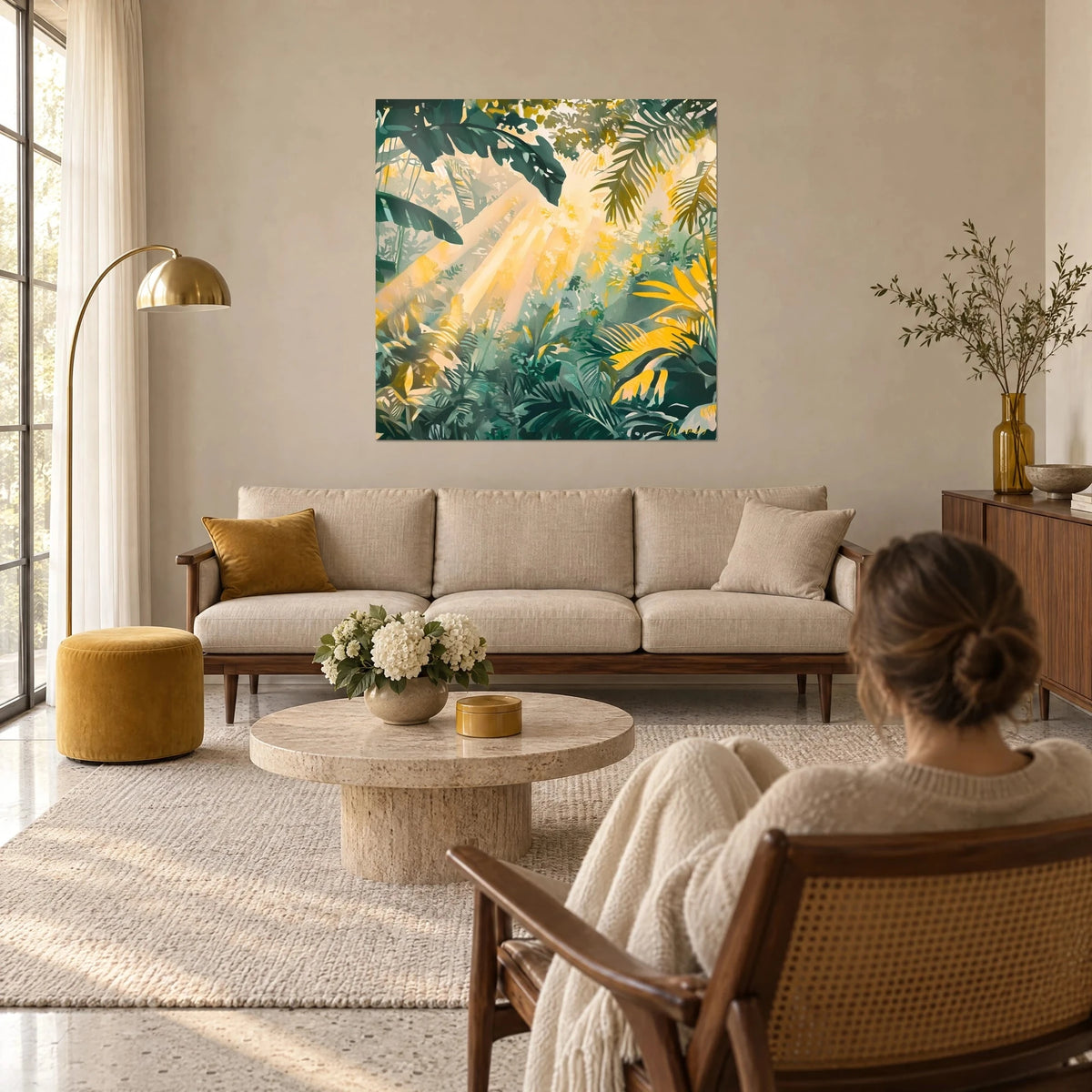 Wall art of a tropical undergrowth bathed in golden rays, fir green and saffron yellow foliage, above a sofa in a bright living room