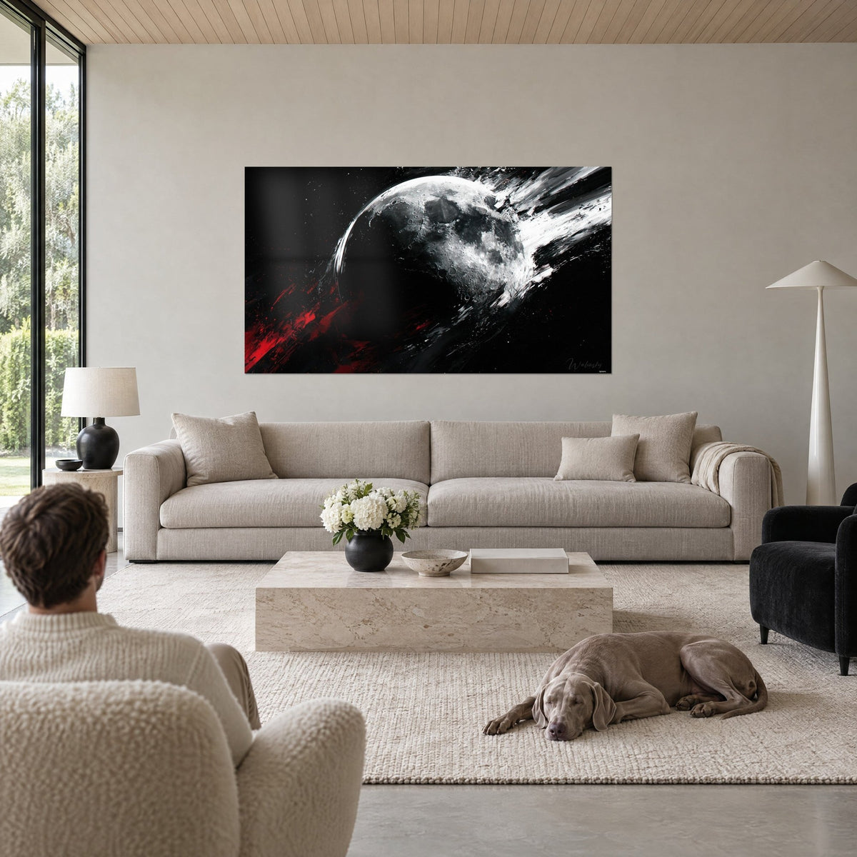 Cuadro astro lunar de cráteres gris plateado, pinceladas blancas y salpicaduras rojas, encima de un sofá en un salón luminoso