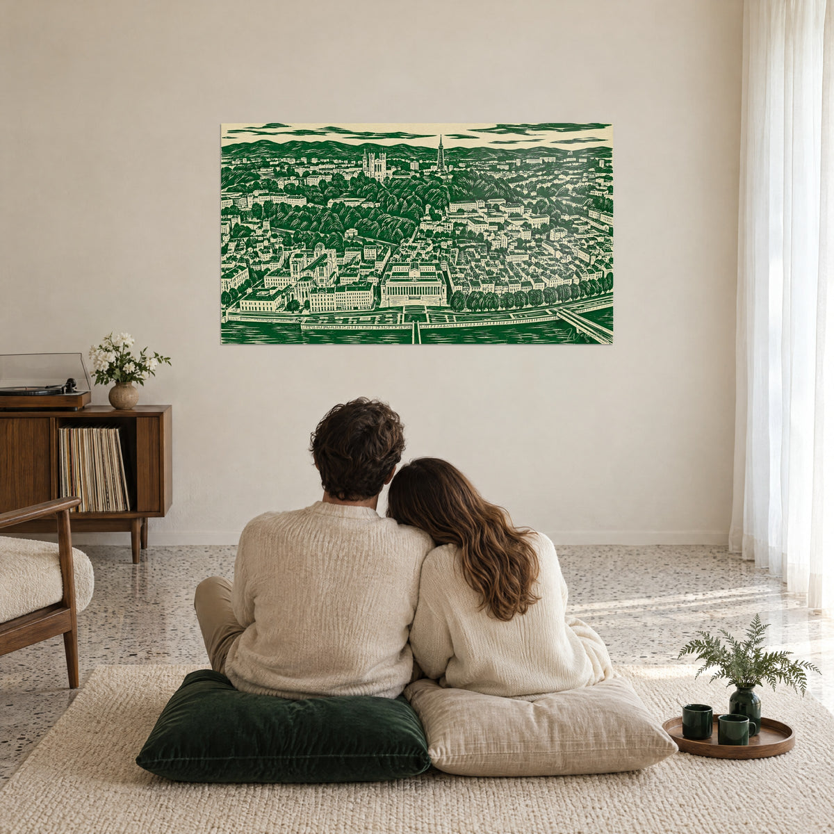 Quadro paesaggio urbano in xilografia verde su fondo crema beige, edifici classici e fiume, due persone abbracciate su cuscini a terra