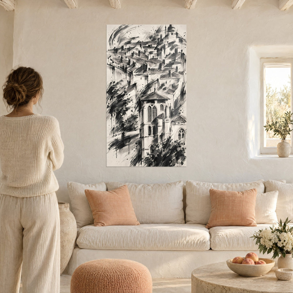 Wall art of the Fourvière basilica in black ink on ivory background, rooftops and chimneys in brushstrokes, above a sofa in a bright living room