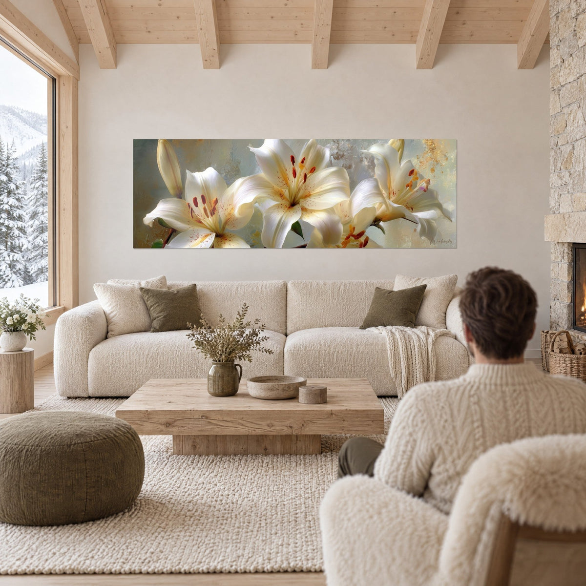 Tableau lys blancs aux étamines orangées sur fond vert-de-gris, dans un salon de chalet, au-dessus d'un canapé dans un salon lumineux