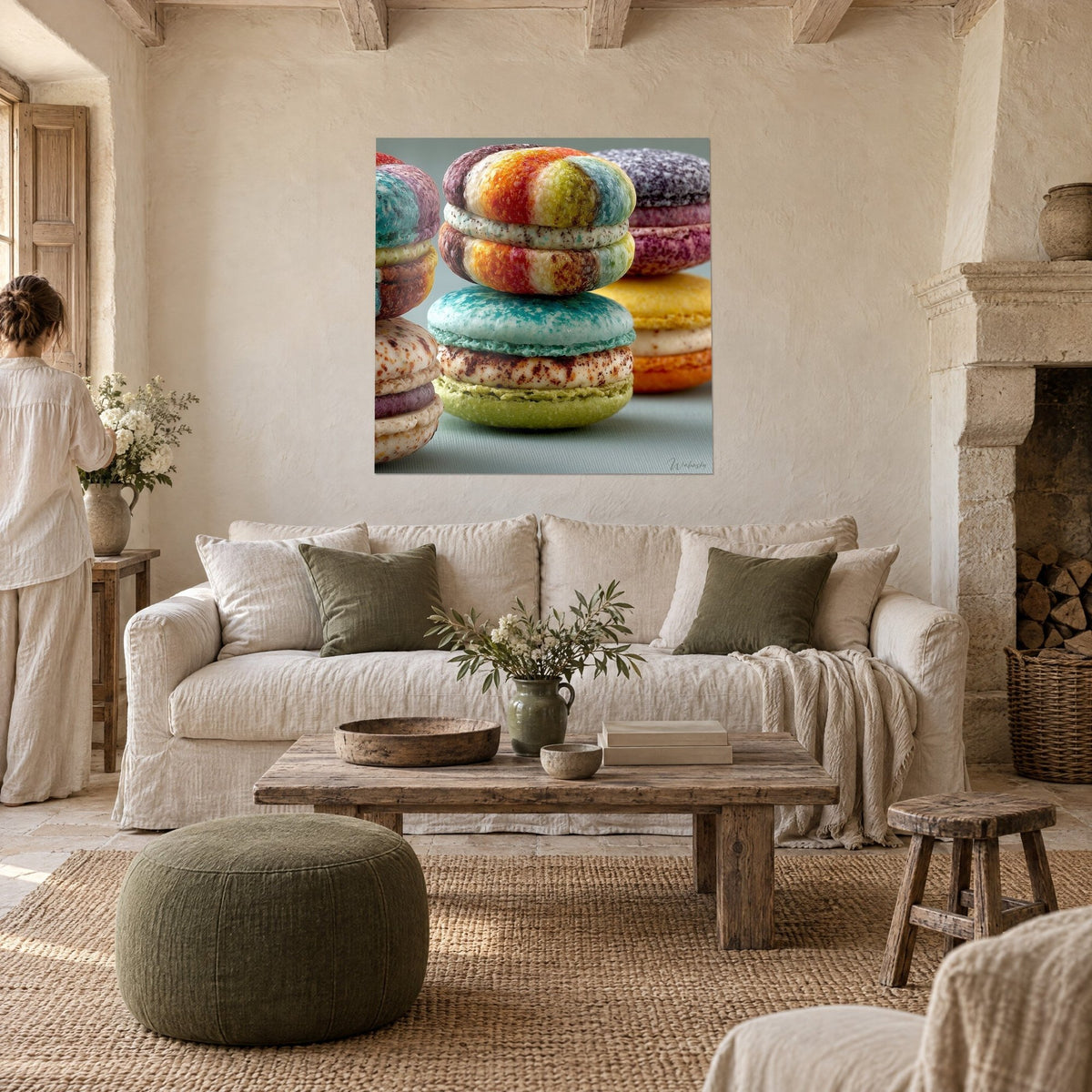 Wall art of stacked macarons with speckled turquoise and green shells, rainbow on top, above a sofa in a bright living room