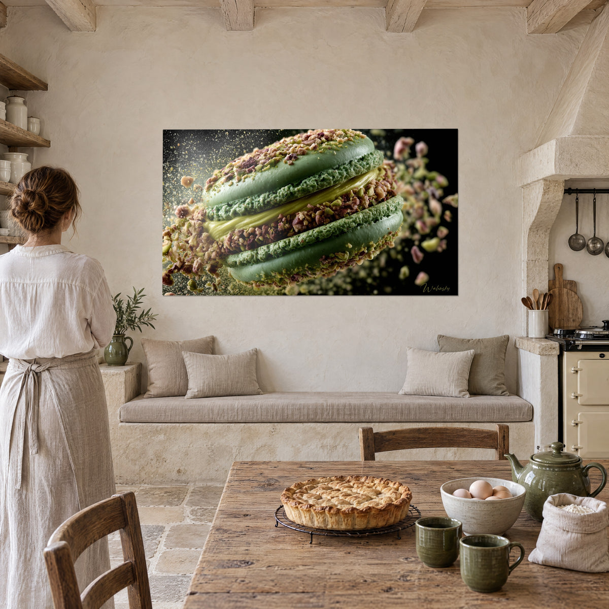 Wall art round pistachio cake with garnet flecks and golden yellow cream, viewed by a woman in white linen in a stone kitchen