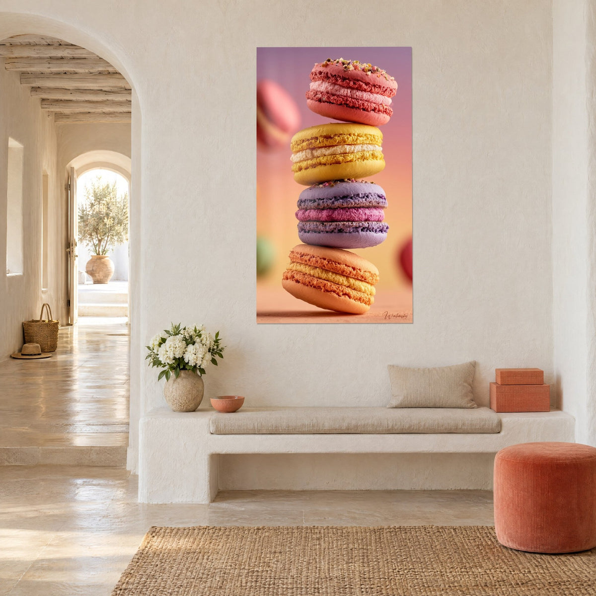 Wall art four indulgent macaron shells stacked on a blurred pink and orange gradient background, hung in a Mediterranean vaulted room