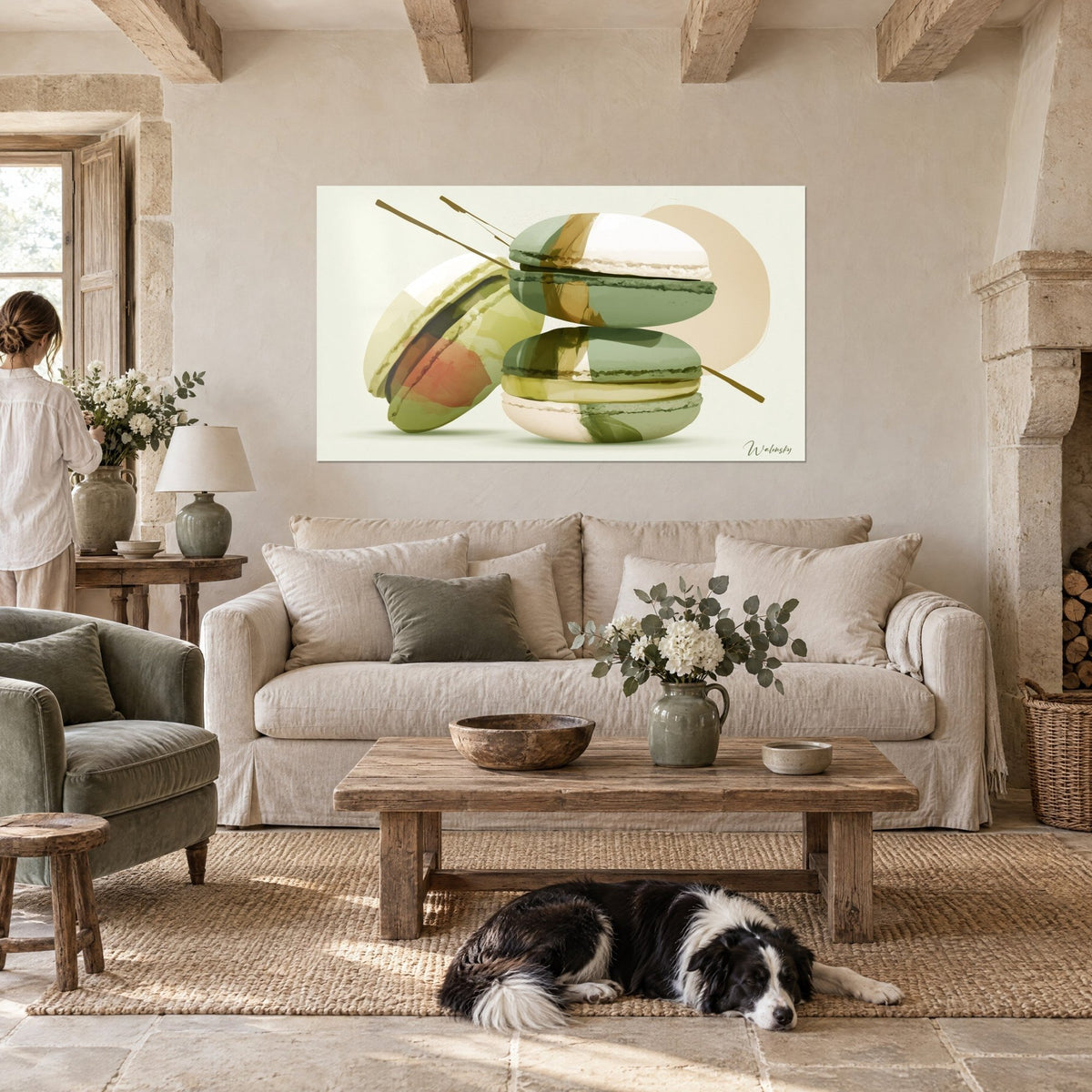 Tableau macarons pistache empilés en aquarelle, coques vert sauge et crème, trait doré, au-dessus d'un canapé dans un salon lumineux