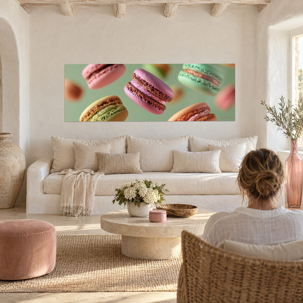 Wall art levitating macarons, raspberry mauve and mint green on sage background, above a sofa in a bright living room