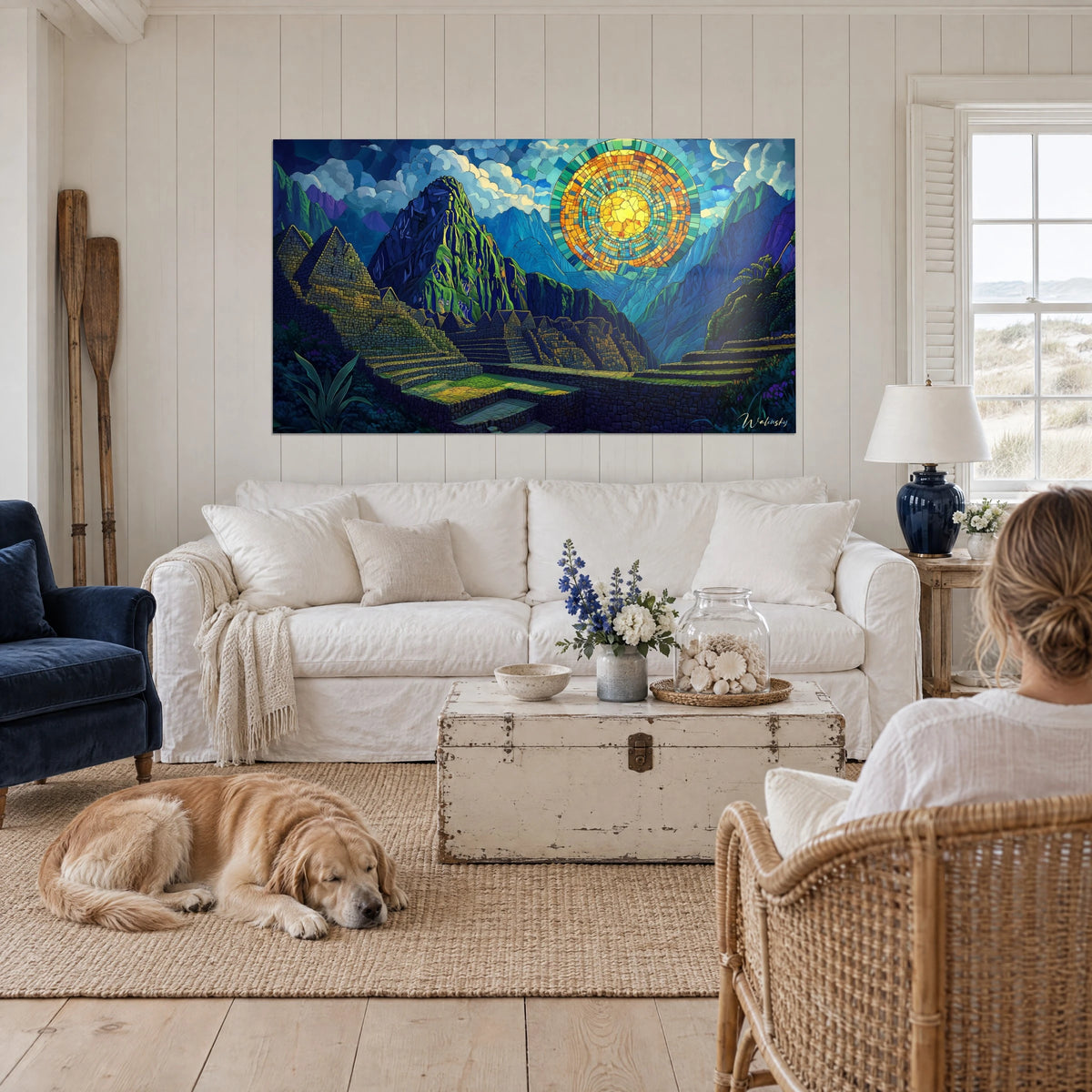 Wall art Machu Picchu in stained glass, orange and gold sun over blue mountains, with a resting retriever, above a sofa in a bright living room