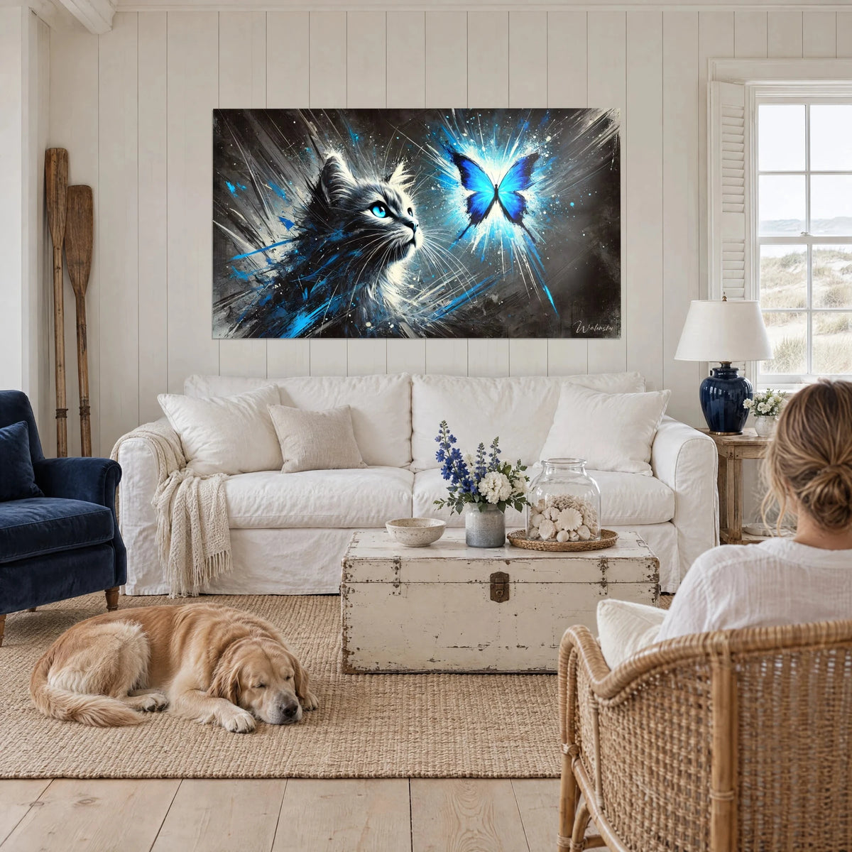 Wall art kitten with electric blue eyes fixing on a luminous butterfly, black and white, retriever above a sofa in a bright living room