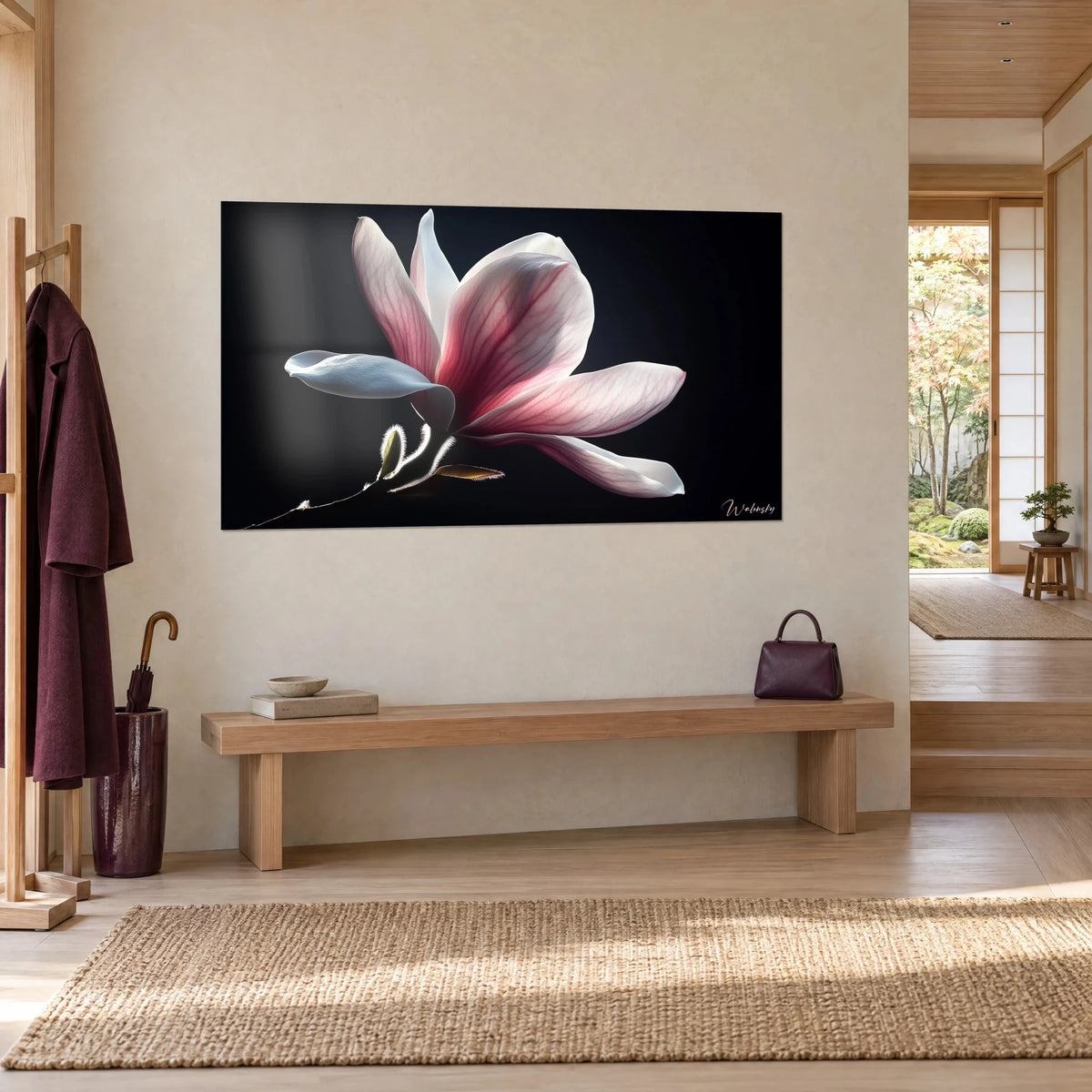 Wall art of a magnolia bloom with vibrant pink veined petals and pearly white tones, hung in a japandi entryway of light wood