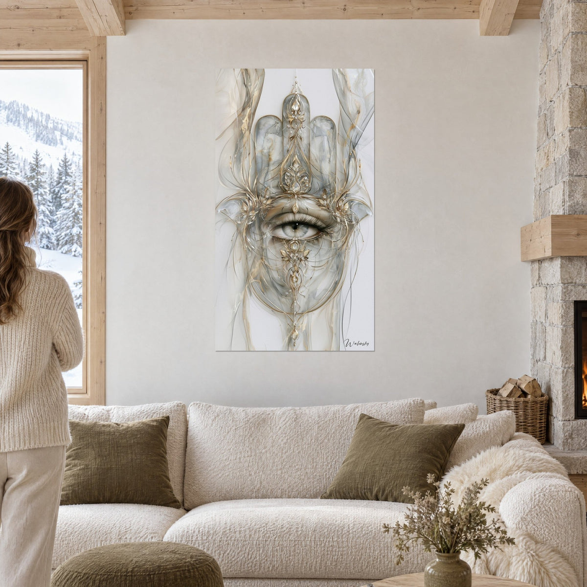 Wall art Fatma's hand in translucent grey and gold, eye with fine lashes, gold filigree, above a sofa in a bright living room
