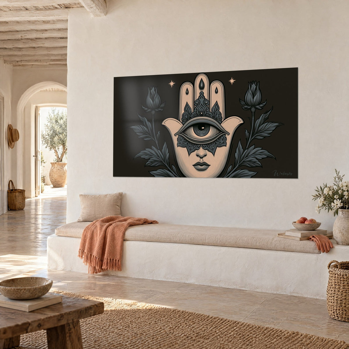 Cuadro talismán hamsa color arena con ojo abierto, pétalos antracita y dos estrellas doradas, pared crema, banqueta clara