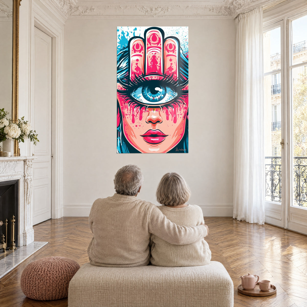 Wall art pink and blue Hamsa talisman on a female face, almond-shaped eye with dark lashes, viewed by an elderly couple embracing in a sunlit living room