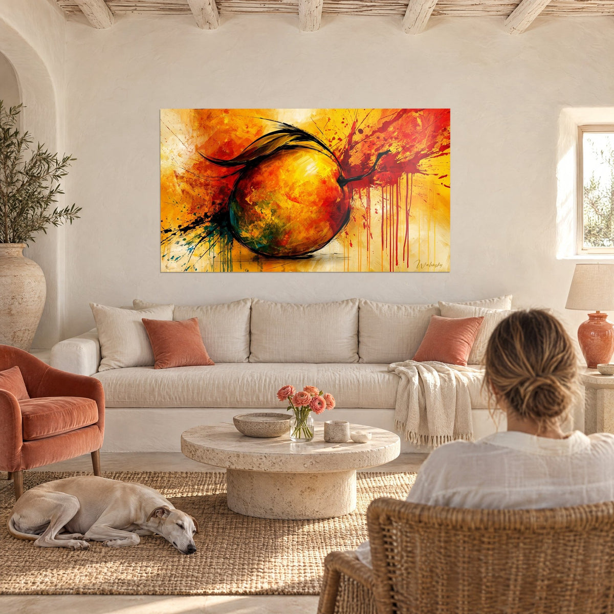 Wall art mango splashed with ink, yellow and red, black drips, woman seen from behind and greyhound, above a sofa in a bright living room