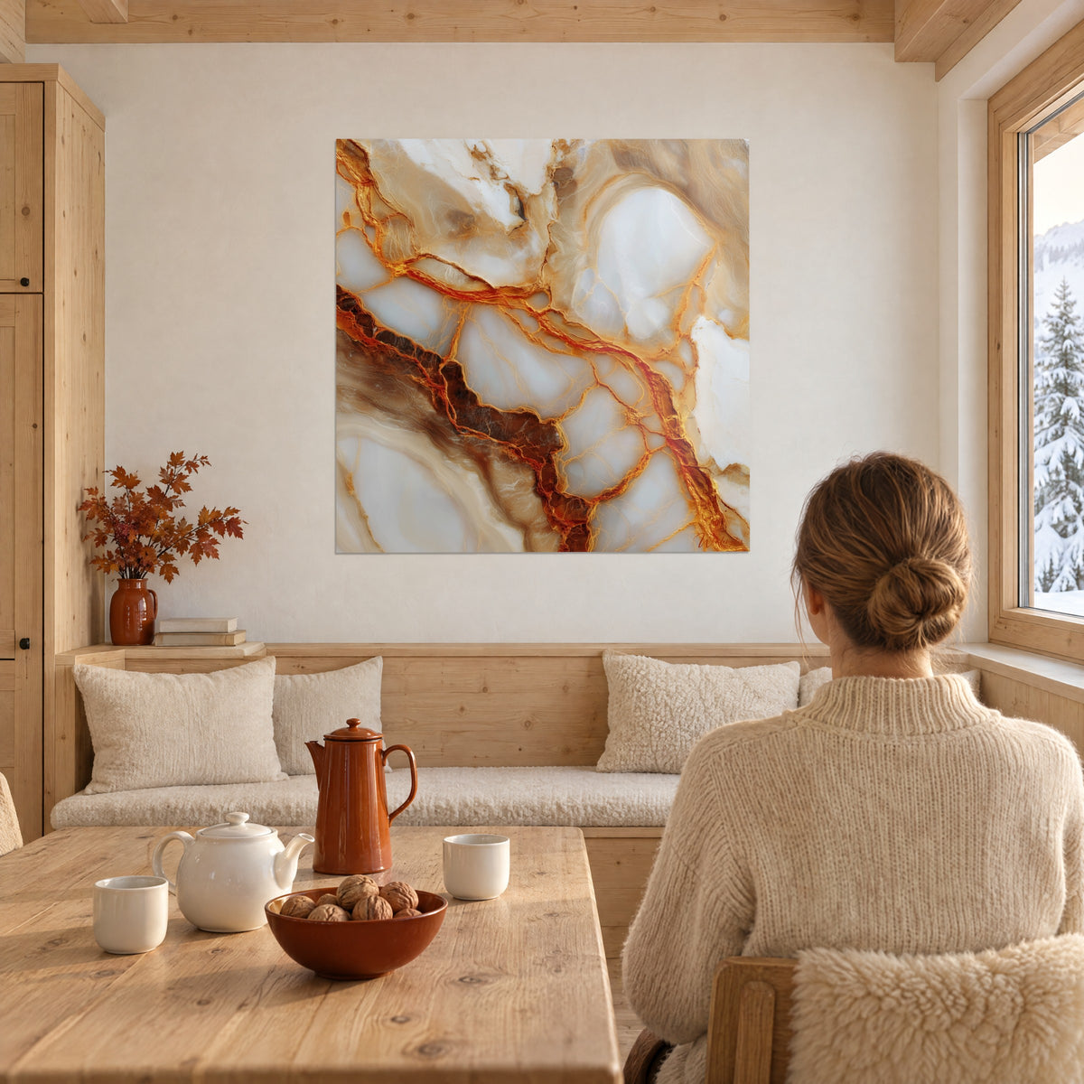 Abstract mineral wall art with amber cracks on ivory white, a woman seen from behind, wooden table and copper teapot in the chalet