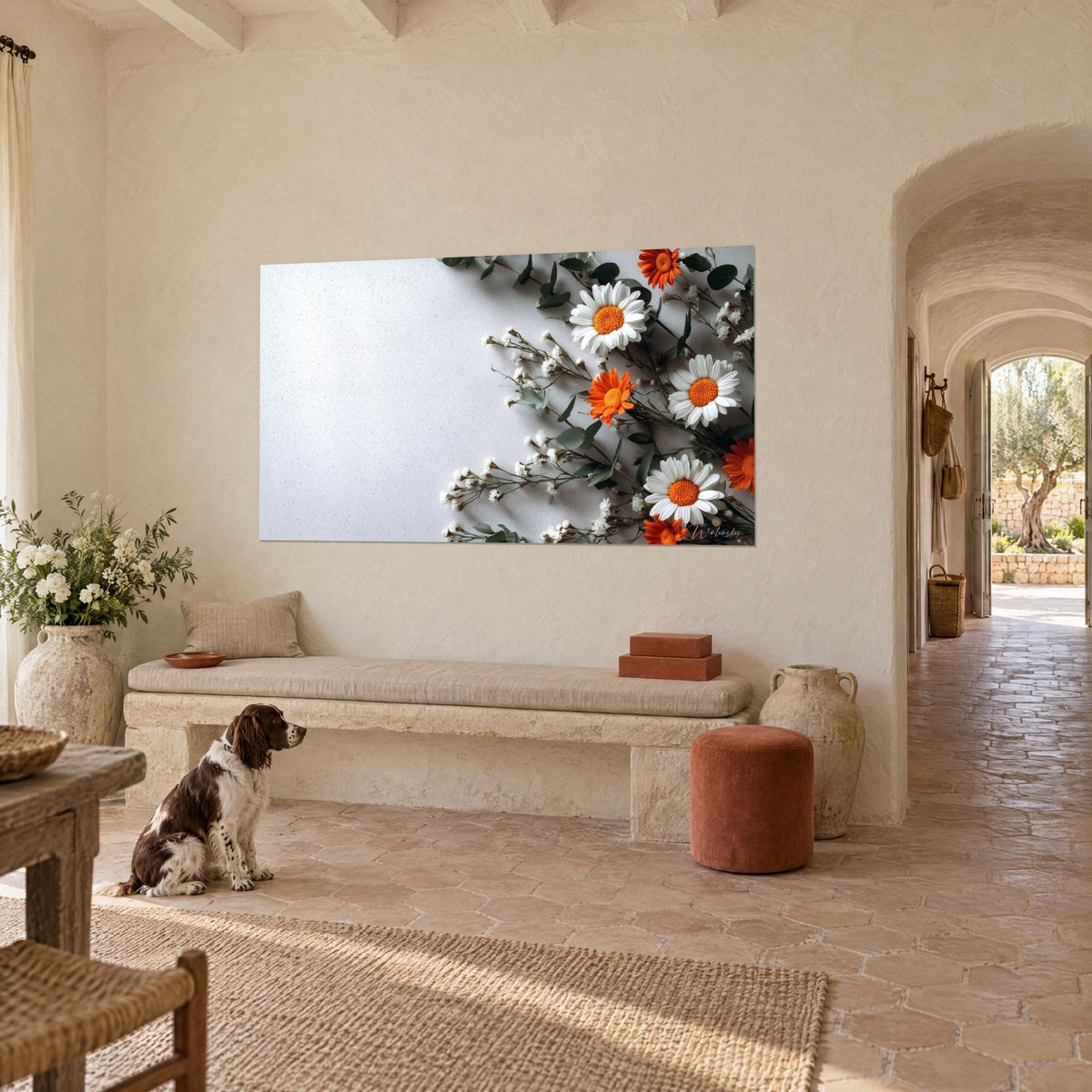 Wall art bouquet of immaculate daisies and orange flowers on sage-green eucalyptus, brown and white spaniel sitting in a Provençal farmhouse