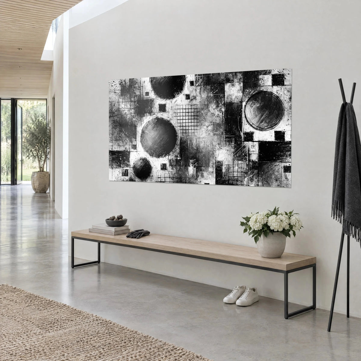 Wall art dark ink circles, fine checkerboards and black squares in textured white paint, light wall above a wooden bench
