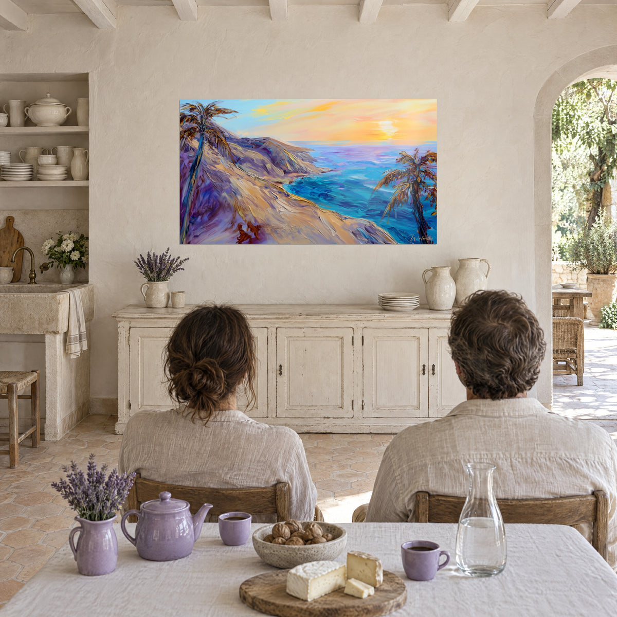 Schilderij van een diepblauwe oceaanbaai, lila en okerkleurige duin, geel-oranje lucht, tegenover een ontbijttafel in een Provençaalse boerderij