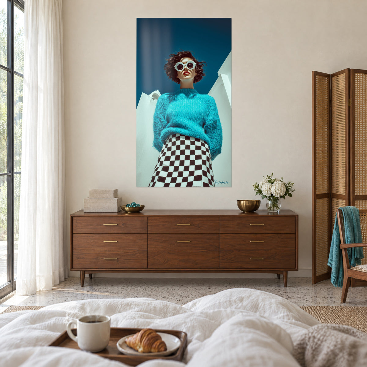 Wall art of a silhouette with red lips and brown curls, turquoise sweater, navy blue background, above a bed in a light bedroom