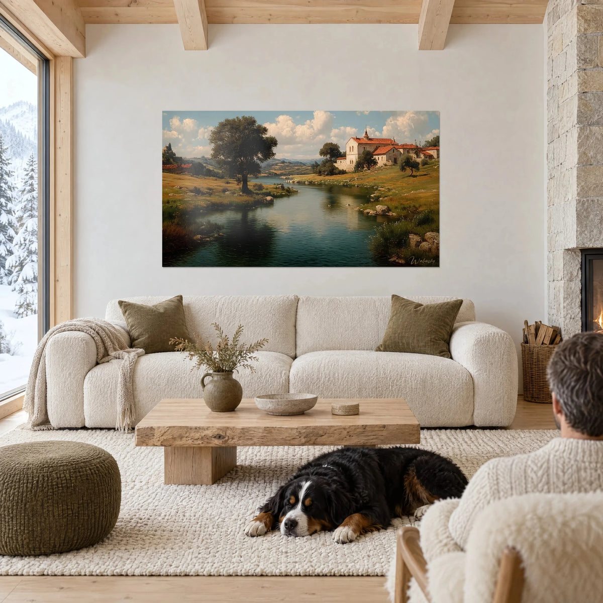 Gemälde Kloster mit roten Dächern am Ufer eines grün-blauen Flusses, ruhender Hund, über einem Sofa in einem hellen Wohnzimmer