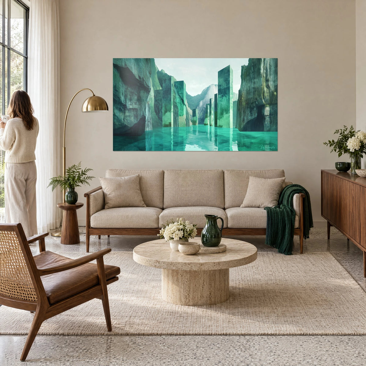 Wall art of emerald monoliths rising from a turquoise lake between cliffs, above a sofa in a bright living room