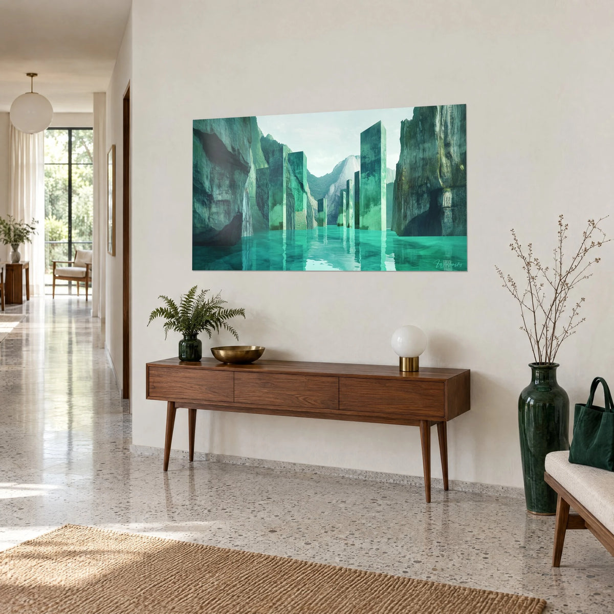 Wall art of jade columns rising from turquoise water, mossy grey cliffs, hung above a walnut sideboard, three-quarter view