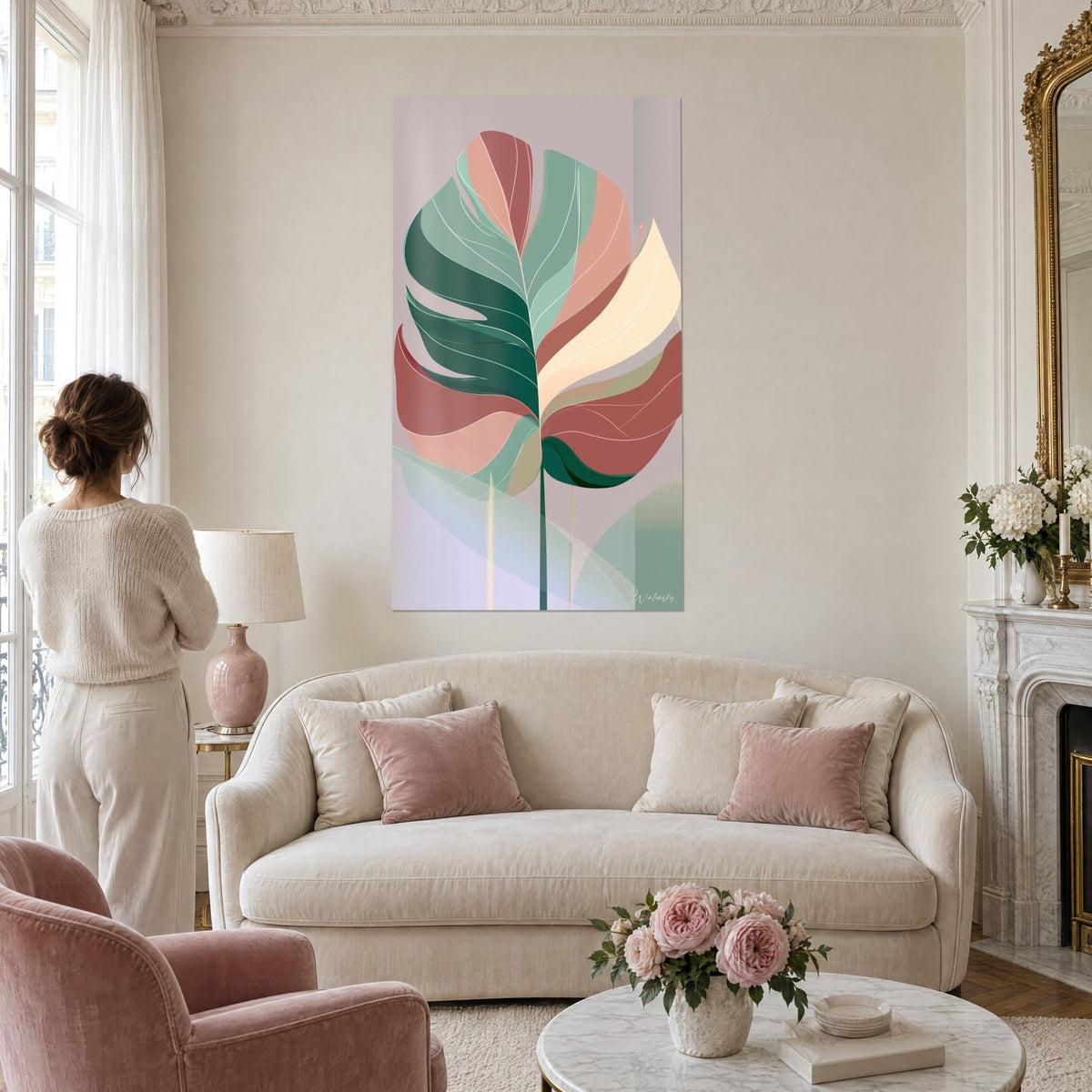 Wall art monstera leaf in fir green, salmon pink and cream flat tones, a woman seen from behind above a sofa in a bright living room