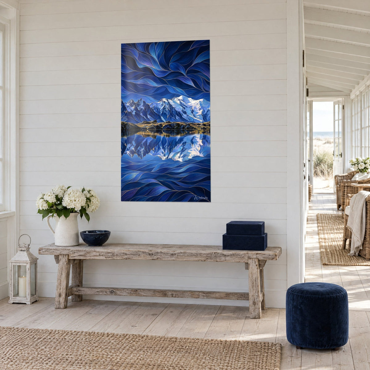 Wall art glacier peaks and water mirror, swirls of indigo and silver, three-quarter view on the wall of a seaside house