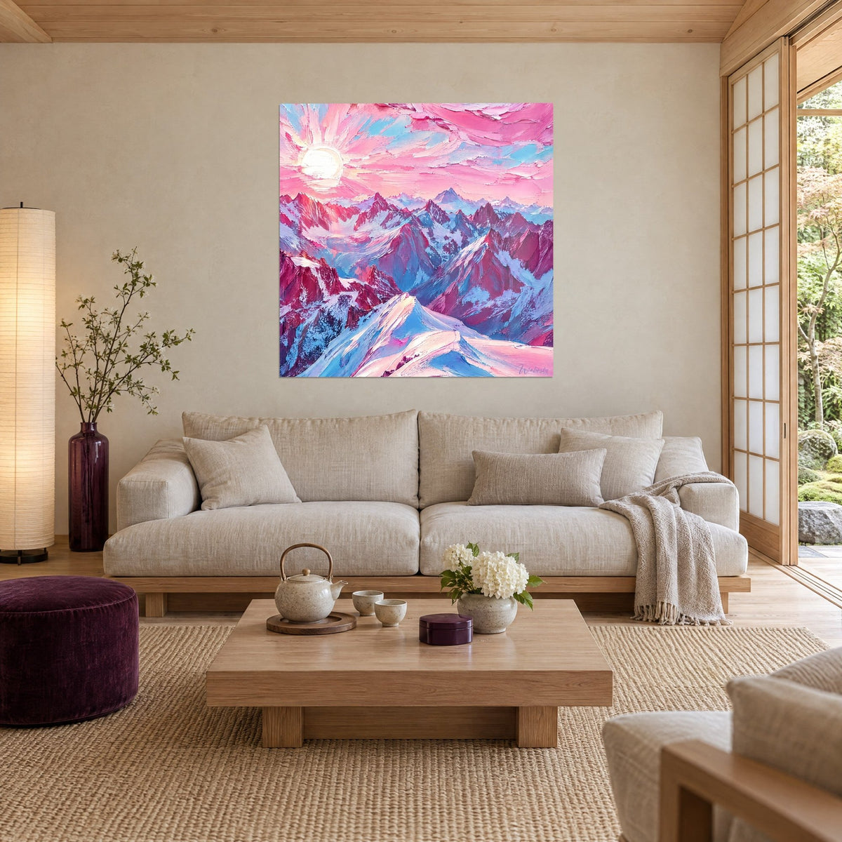 Wall art snowy peaks in pink and blue, radiant white sun and palette-knife impasto, above a sofa in a bright living room