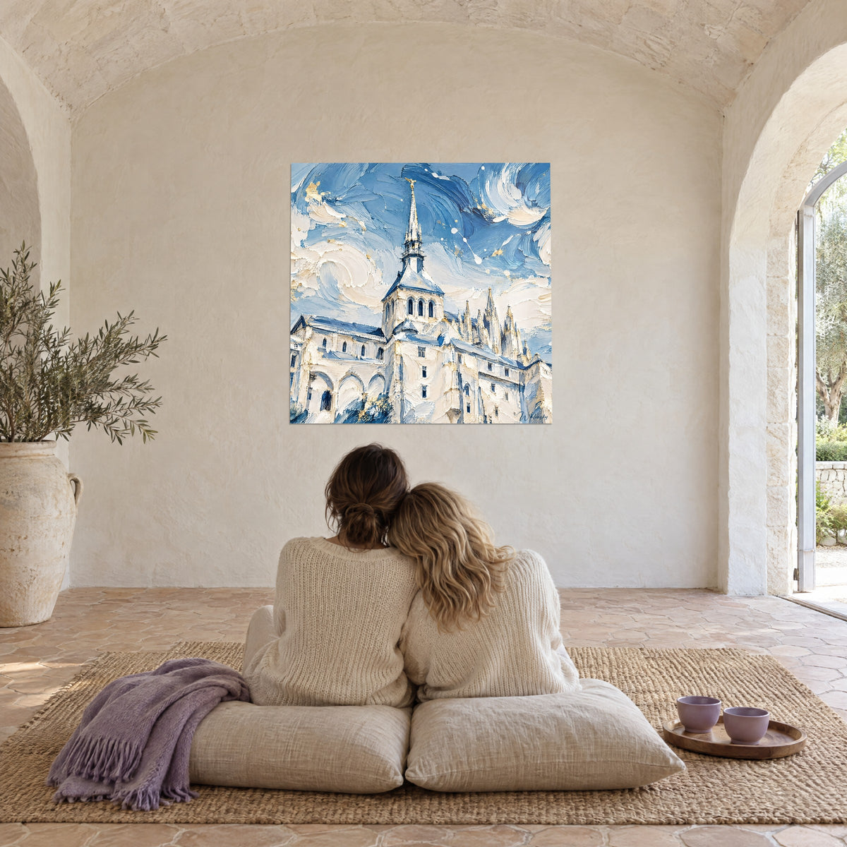 Wall art palette-knife sculpted abbey, ivory and sky blue, admired by a couple seated back to the viewer on cushions