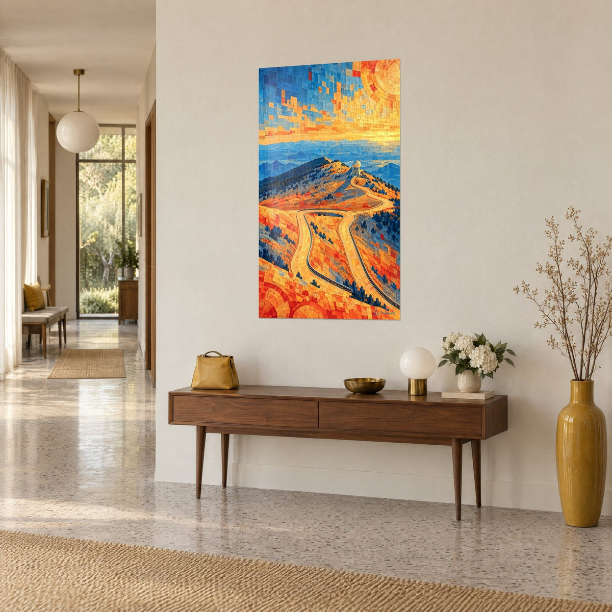 Wall art bare summit of Mont Ventoux in amber and indigo tiles, ribbon of hairpin bends, on a beige wall beside a wooden console