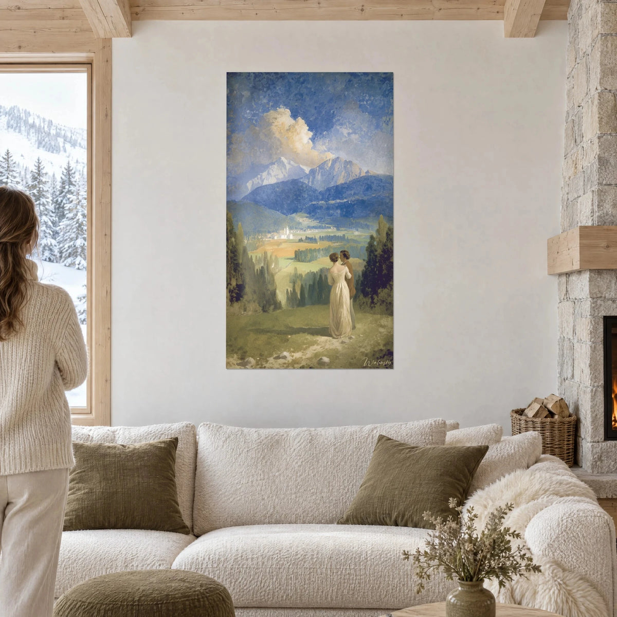 Quadro coppia abbracciata di fronte alla valle, abito color crema e vette blu cobalto, sopra un divano in un soggiorno luminoso