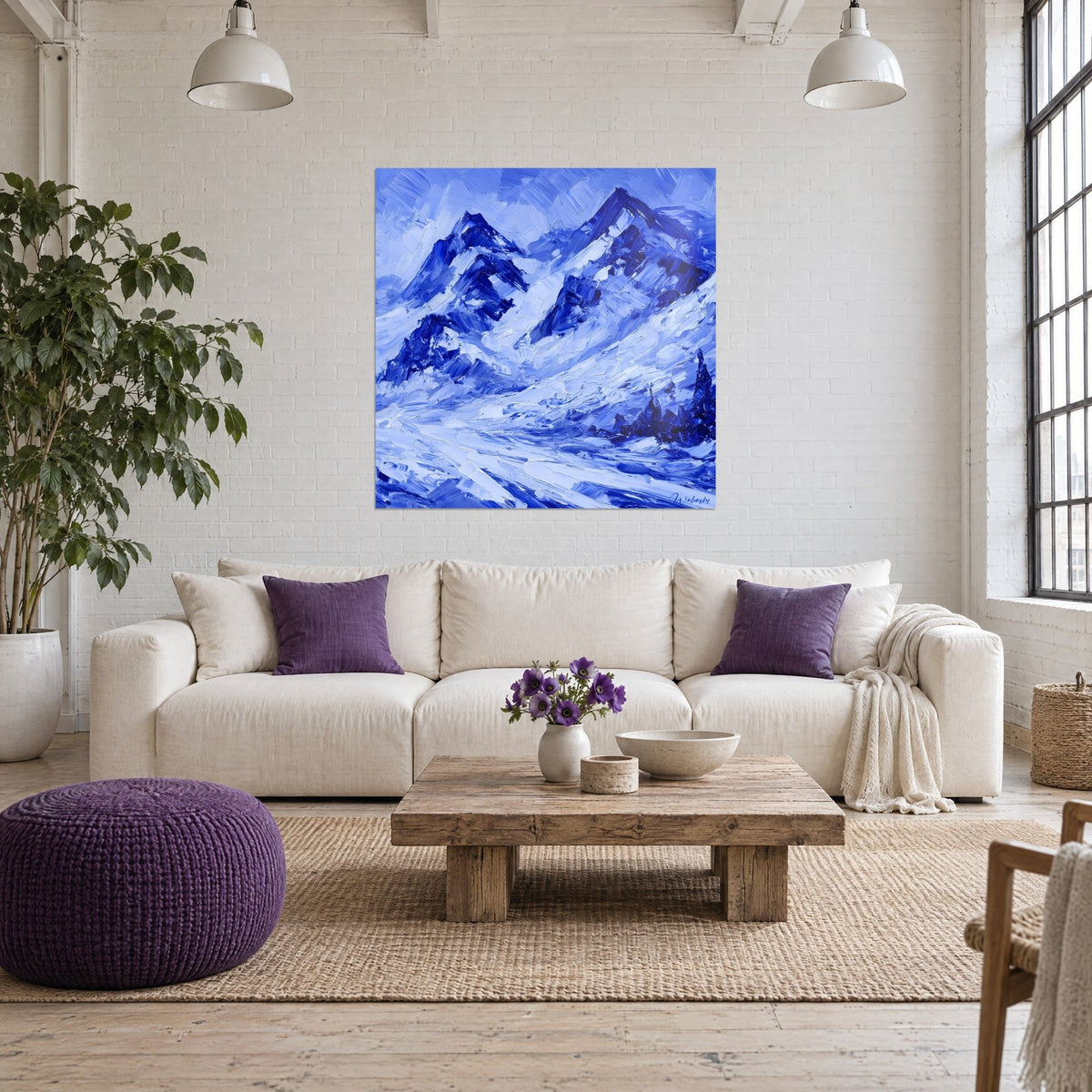 Wall art of snowy peaks with navy blue and frosted white ridges, thick palette-knife strokes, above a sofa in a bright living room