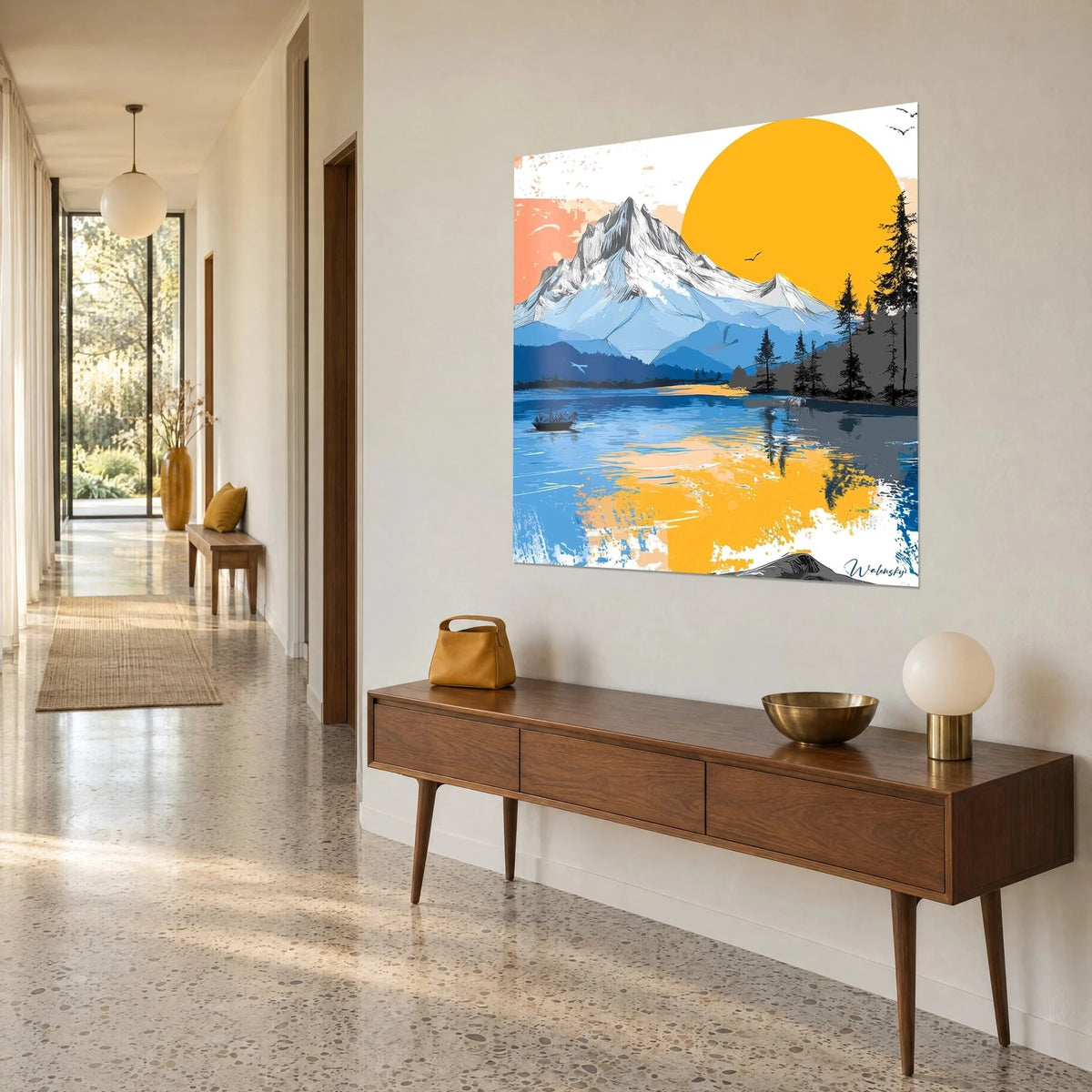 Wall art icy summit overlooking an azure lake, golden yellow sun disc and dark pines on the right, on a wooden sideboard in a hallway