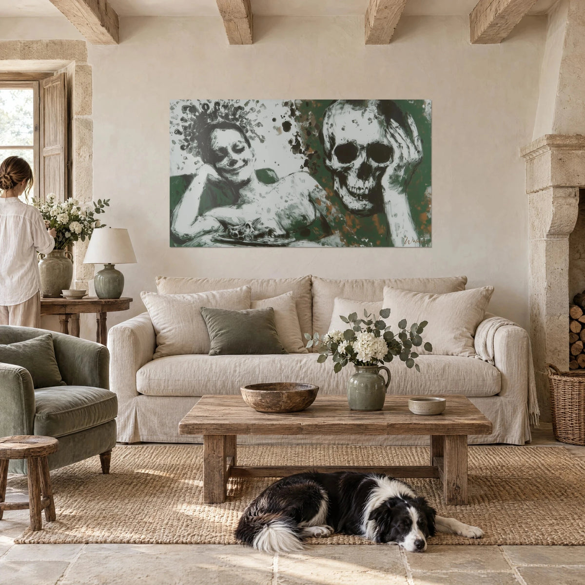 Wall art vanitas of a laughing woman facing a skull, fir green and off-white, above a sofa in a bright living room