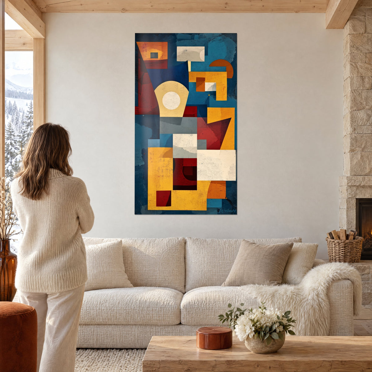 Wall art mosaic of saffron yellow and deep blue blocks, woman seen from behind, above a sofa in a bright living room