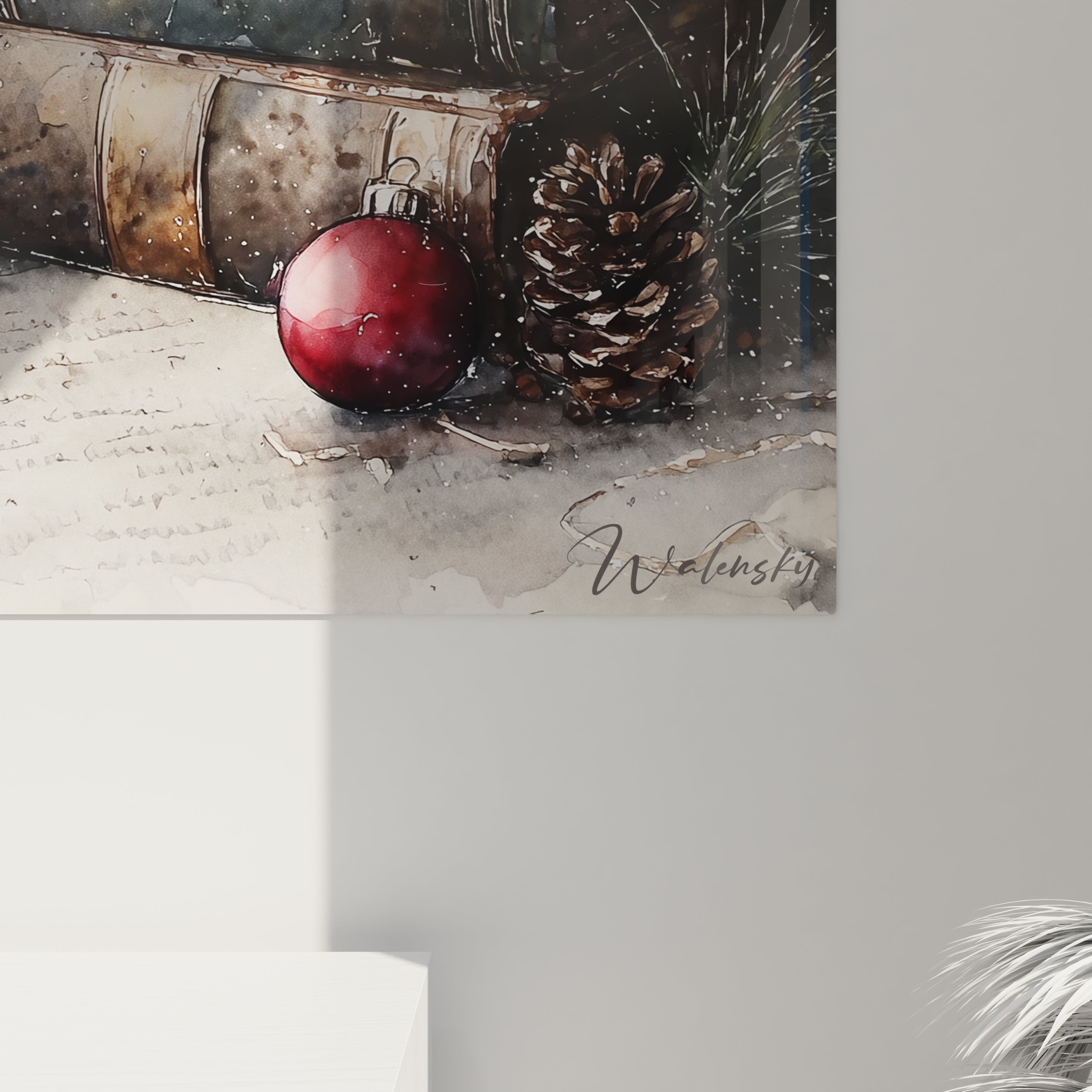 Tableau mural Noël livres avec une décoration de boule rouge et des pommes de pin sur une surface neutre