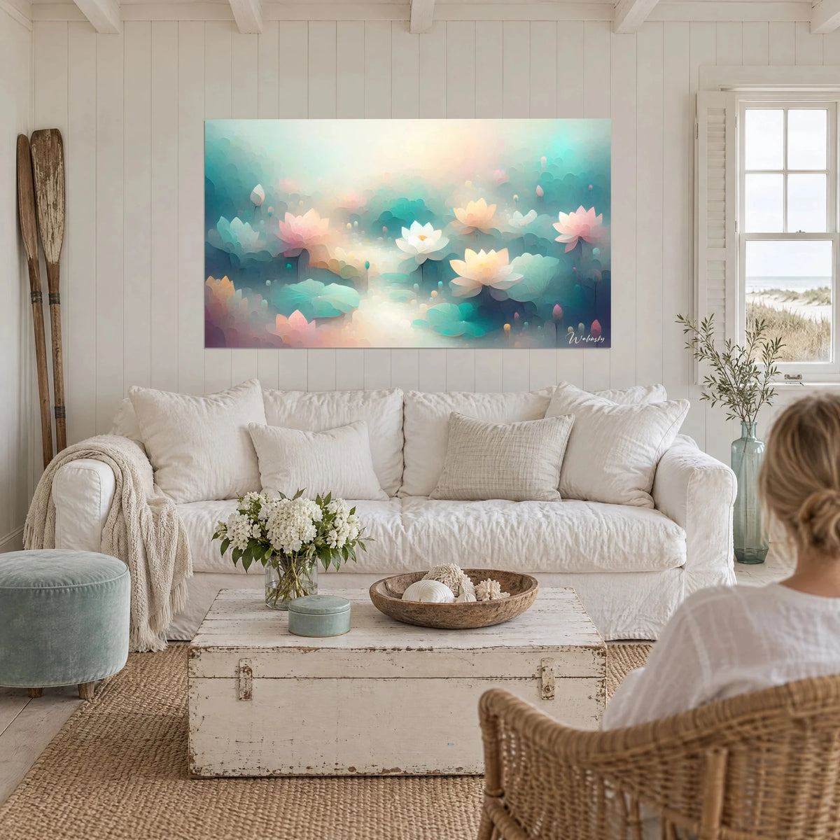 Wall art with pink and turquoise lotus in pastel mist, two ivory water lilies, above a sofa in a bright living room