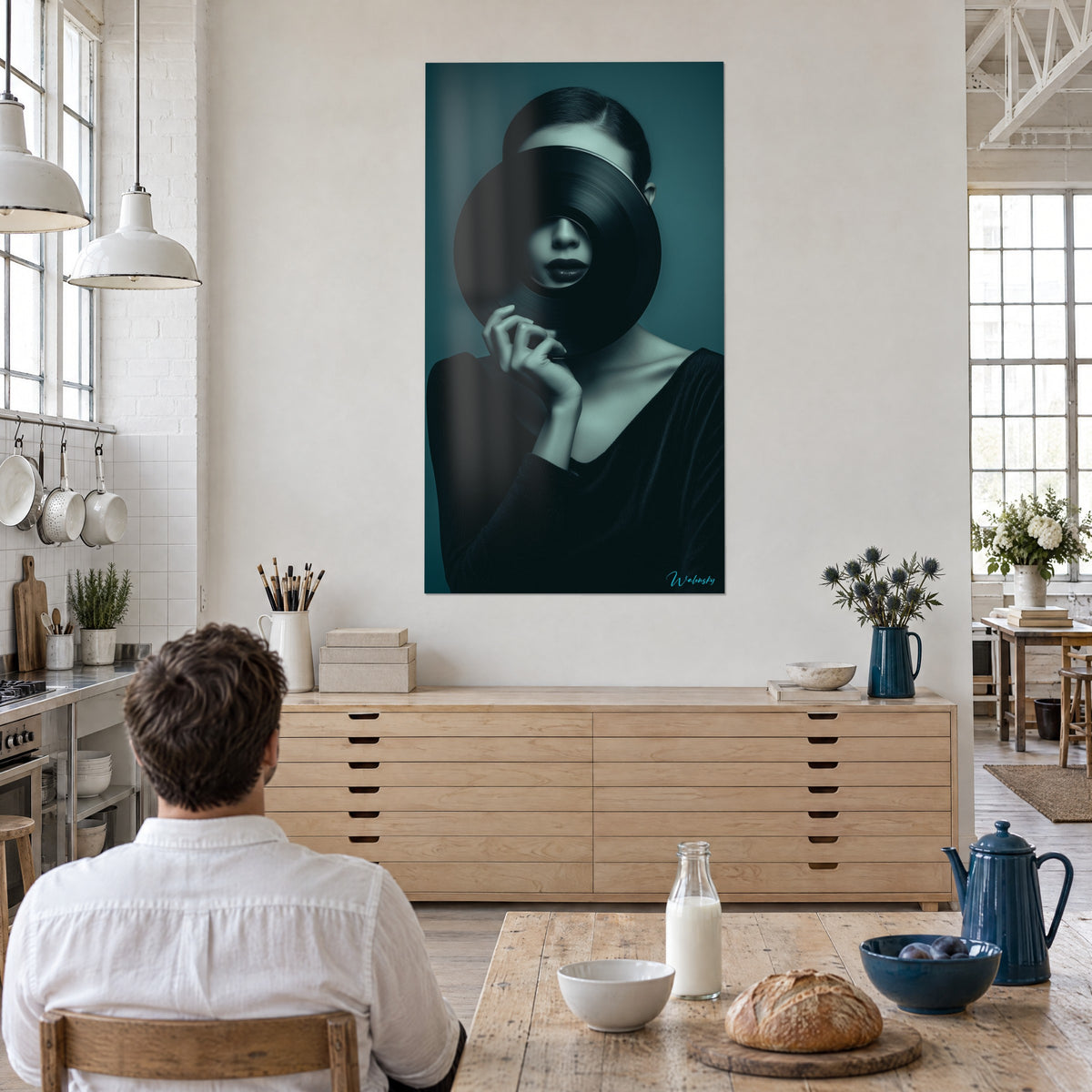 Quadro giovane donna il cui viso è cancellato da un 33 giri, mano sottile sul bordo, blu petrolio e nero, cucina aperta, uomo di spalle