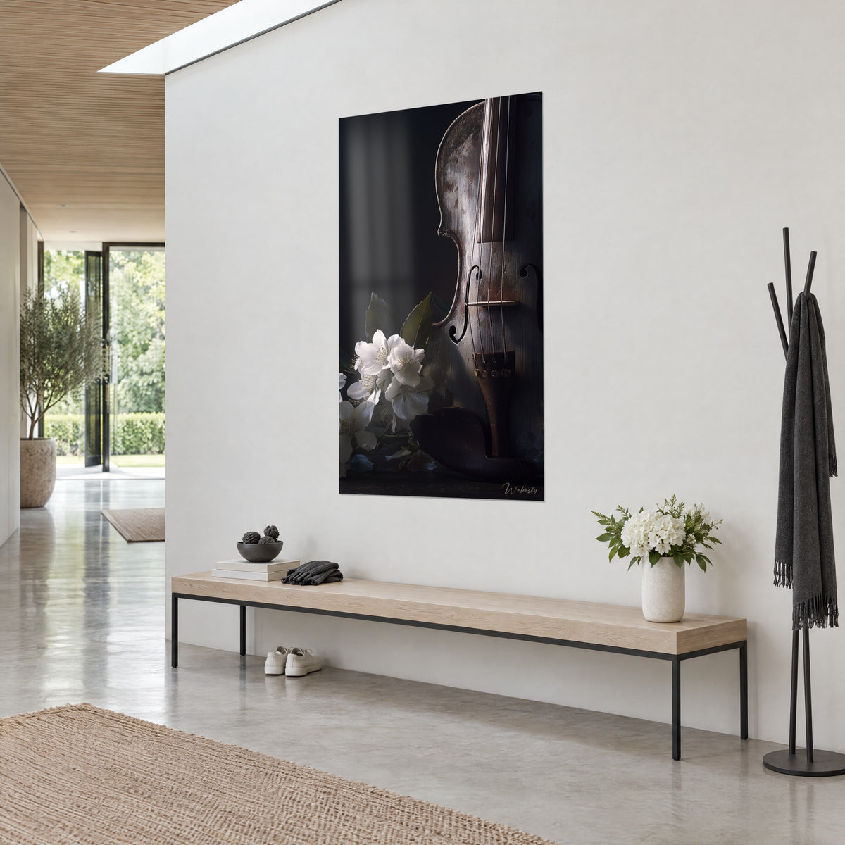 Wall art of an anthracite-brown string instrument with dark sound holes, white bouquet, window reflection, light wall, wooden bench and coat