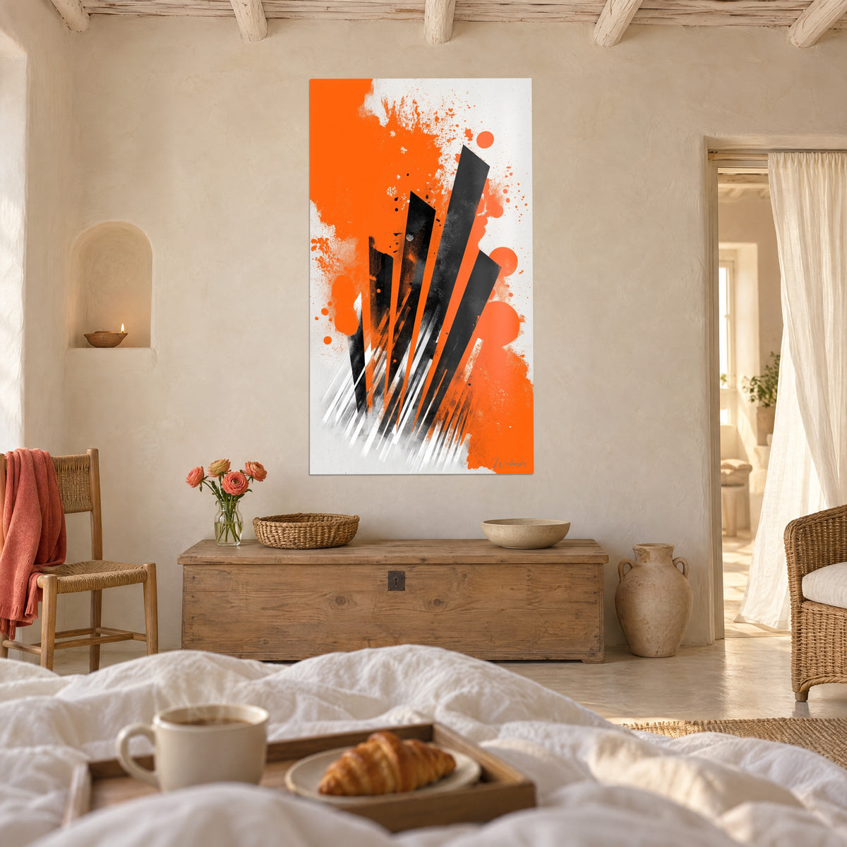 Wall art with a rush of graphite-black rectangles and orange spots, signature at the bottom, hung above a bed in a bright bedroom