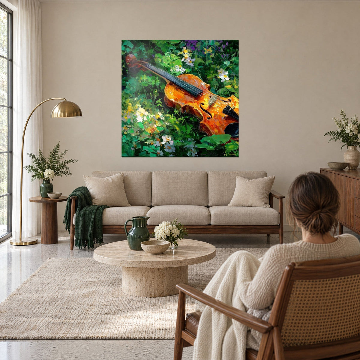 Tableau violon ambré couché dans l'herbe verte, fleurs blanches en touches épaisses, au-dessus d'un canapé dans un salon lumineux
