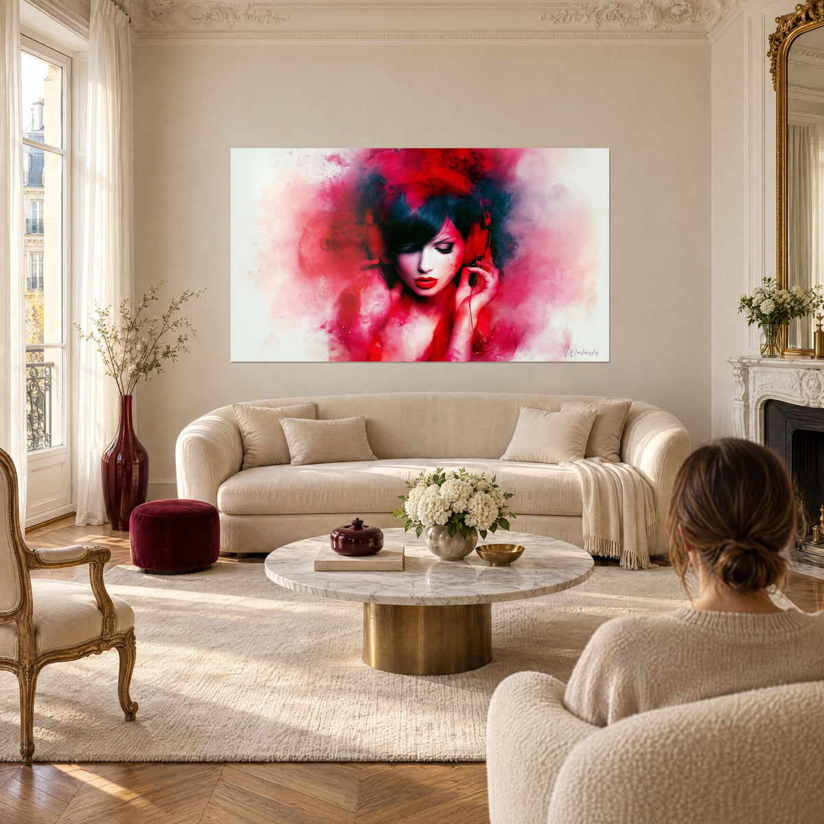 Wall art portrait of a woman with closed eyes and red headphones, carmine and black paint splashes, above a sofa in a bright living room