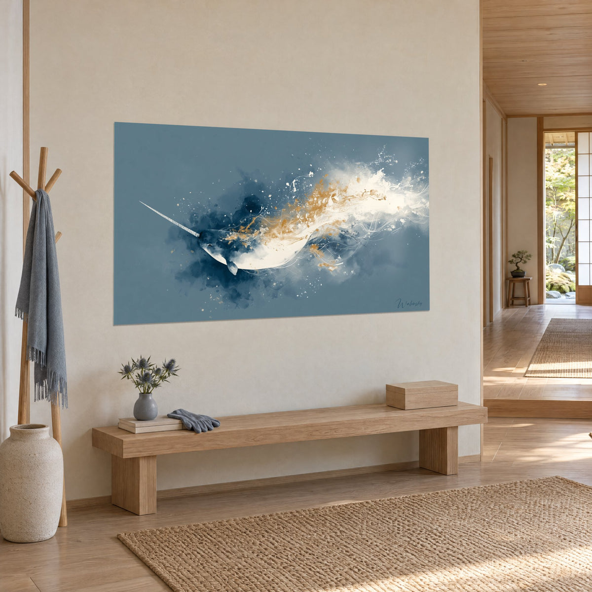 Wall art of a twisted-tusked whale diving through indigo and gold clouds, cream wall, light wood bench, three-quarter view