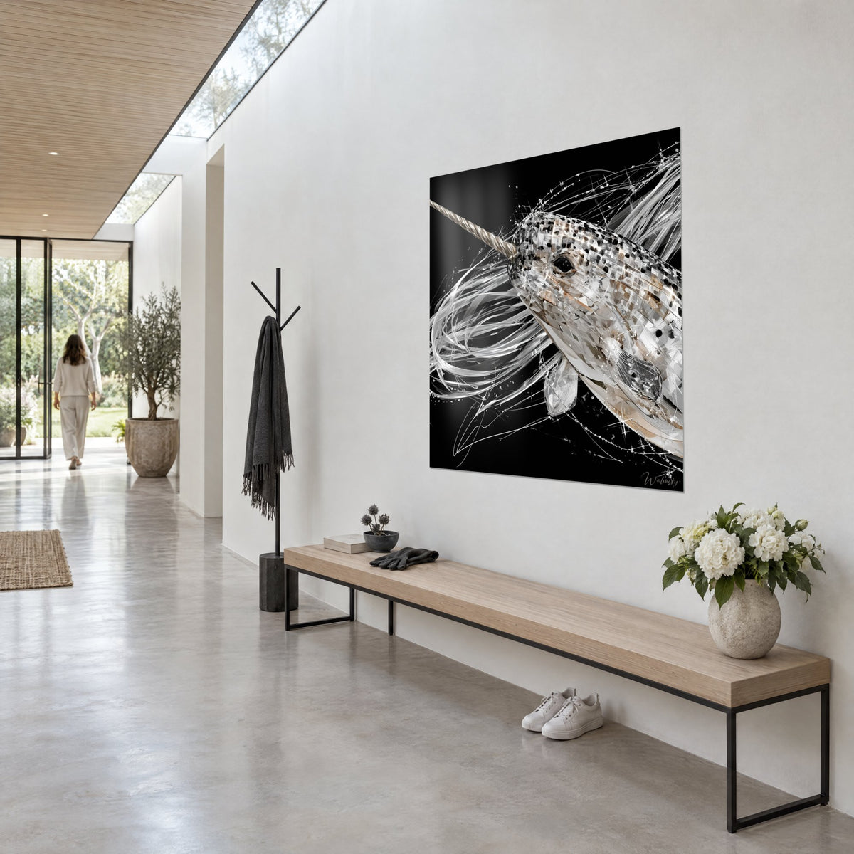 Wall art sea unicorn in white and beige facets, long silver streaks on black, three-quarter view, hallway of an architect's house