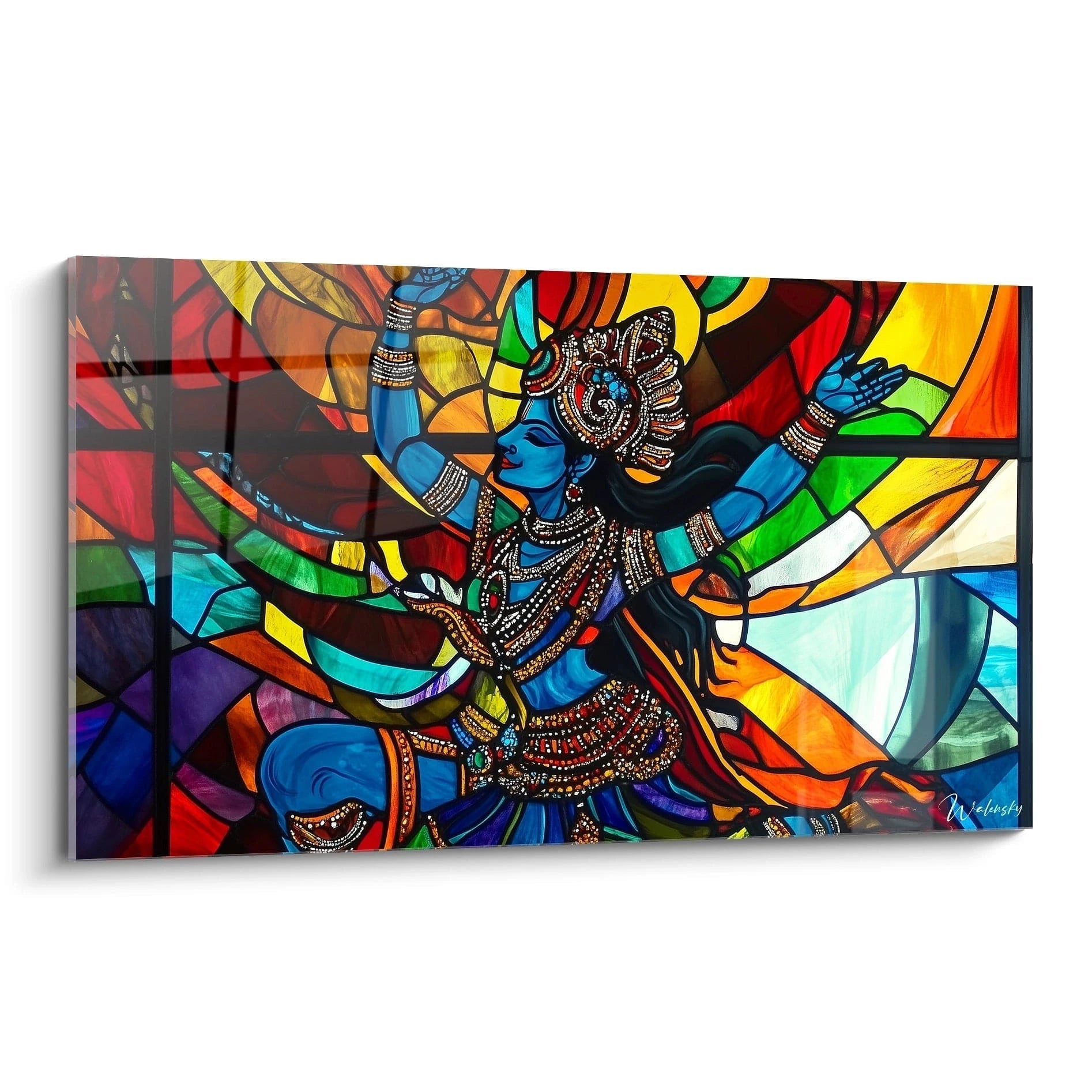 Tableau de style vitrail représentant une divinité hindoue bleue en position de danse, ornée de bijoux dorés et entourée de segments géométriques multicolores aux teintes vives de rouge, jaune, vert et violet, créant un effet kaléidoscopique lumineux.
