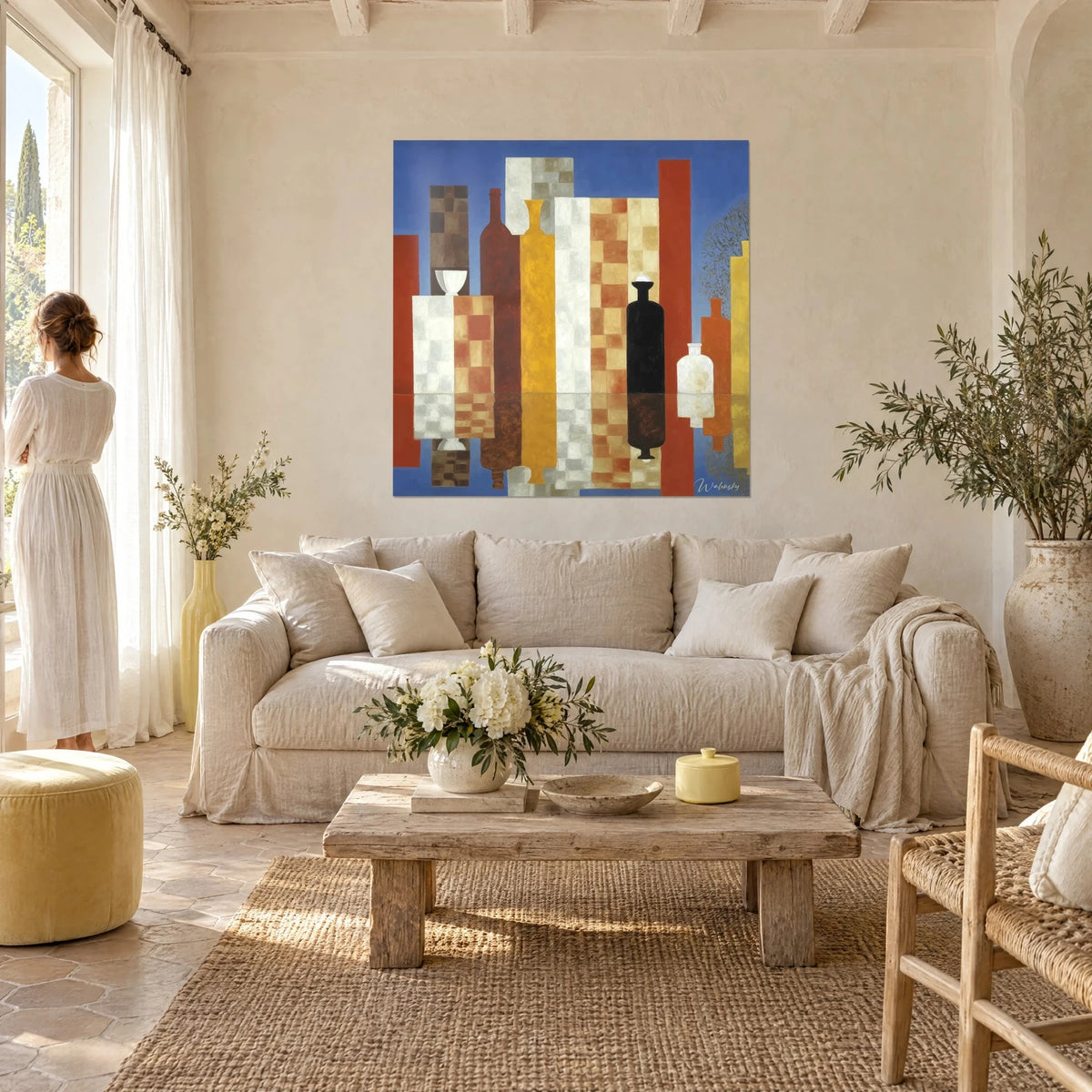 Wall art of cubist bottles on a cobalt blue background, ochre and white checkerboard patterns, yellow vase, above a sofa in a bright living room