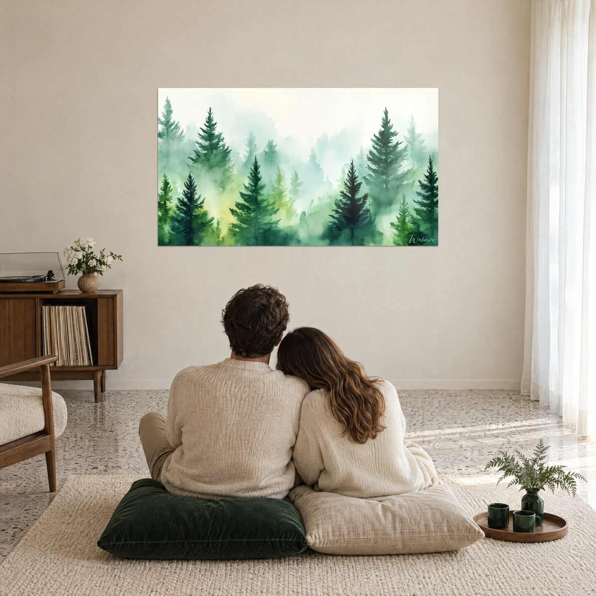 Wall art pine undergrowth in watercolour, bottle green and pale yellow, a couple seen from behind embracing on cushions, beige living room