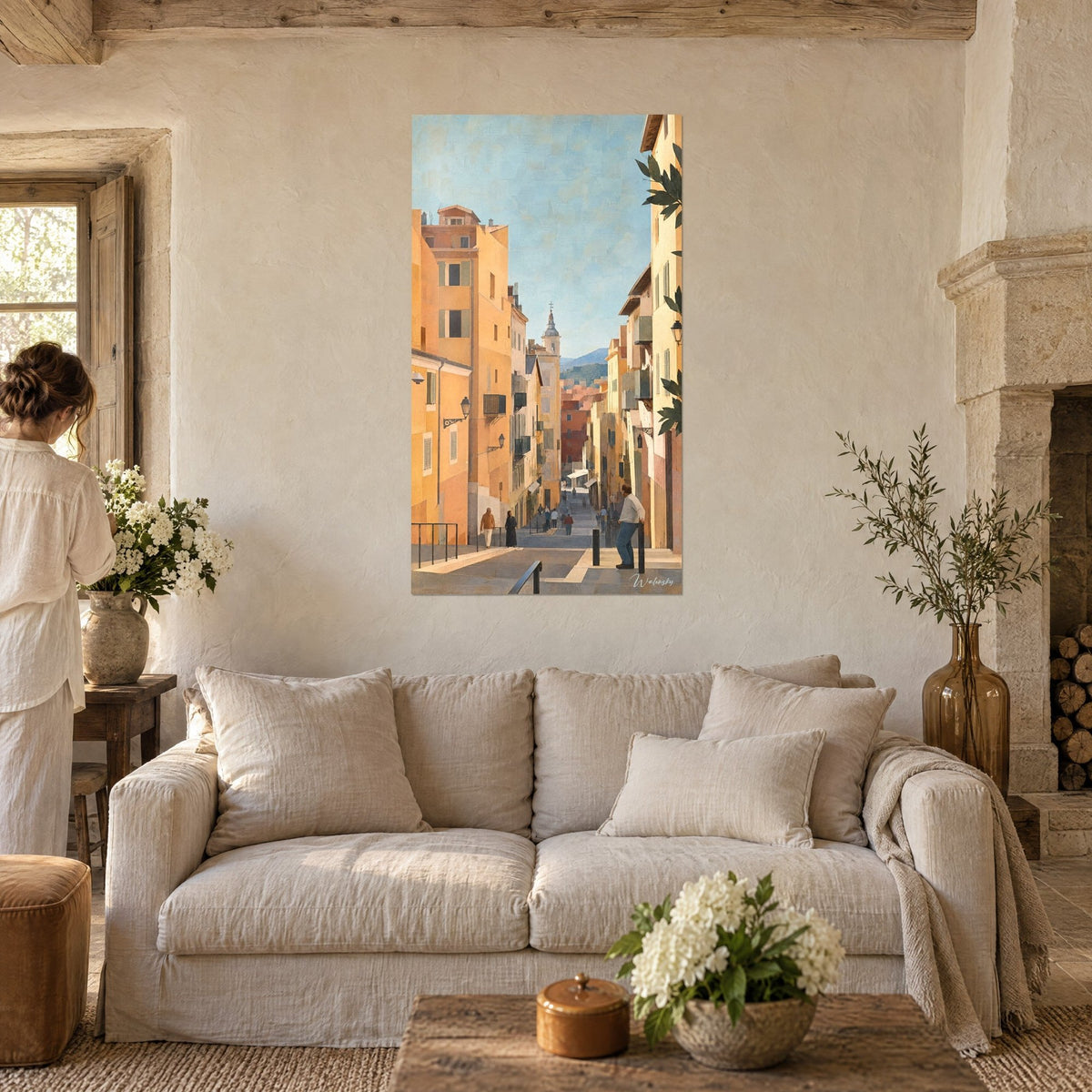 Wall art ochre Nice alleyway sloping down to a bell tower, orange facades and pale blue sky, above a sofa in a bright living room