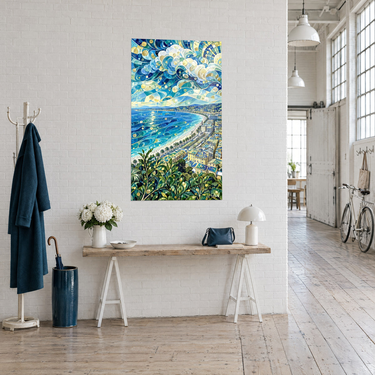 Wall art aerial view of the Promenade des Anglais, azure sea and pale yellow rooftops, on a wooden console in a light loft